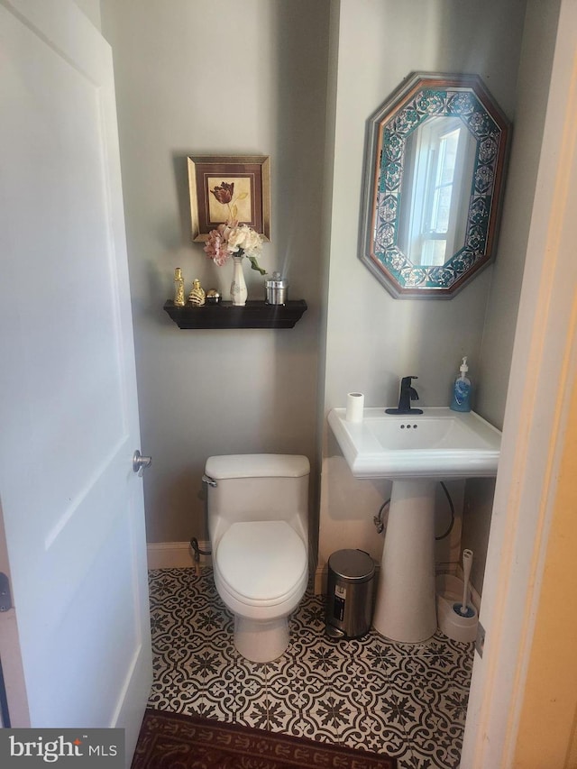 bathroom featuring tile patterned floors and toilet