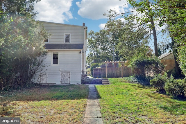 back of property featuring a yard