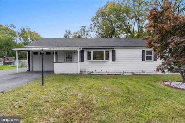 single story home featuring a carport and a front yard