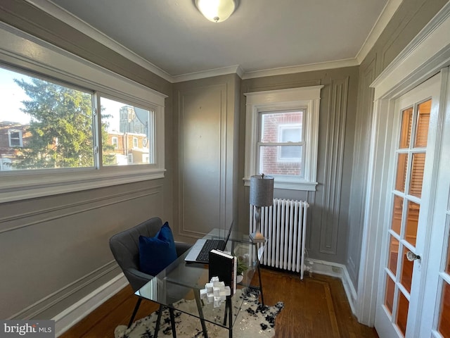 office space with radiator, dark wood-type flooring, ornamental molding, and plenty of natural light