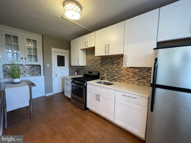 kitchen featuring white cabinetry, appliances with stainless steel finishes, sink, and dark wood-type flooring