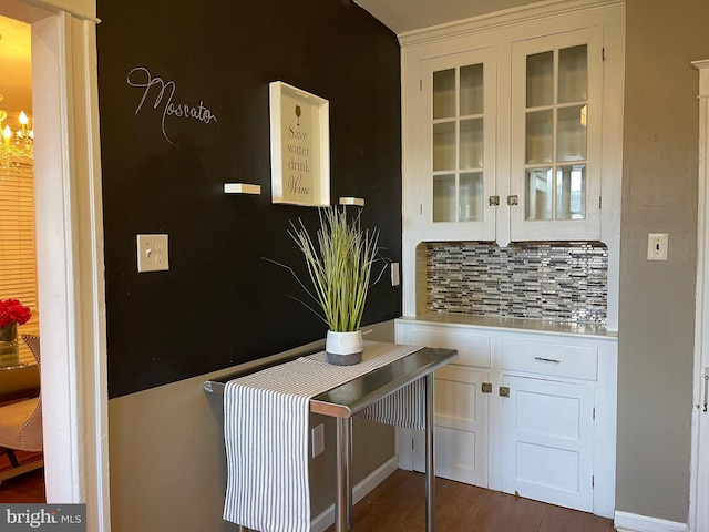 kitchen featuring decorative backsplash, white cabinetry, and dark wood-type flooring