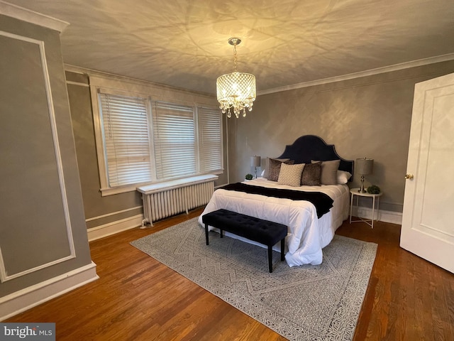 bedroom featuring crown molding, radiator heating unit, a chandelier, and dark hardwood / wood-style flooring