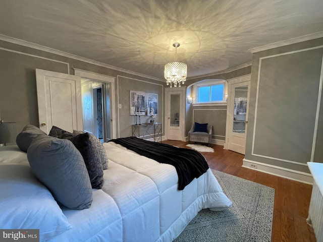 bedroom featuring ornamental molding, a chandelier, and dark hardwood / wood-style floors