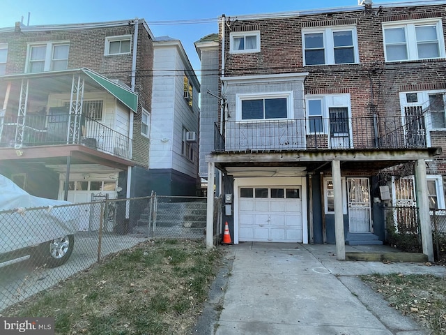 multi unit property featuring a balcony and a garage