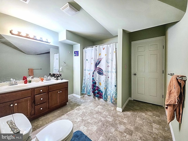 bathroom with toilet, vanity, and a shower with shower curtain