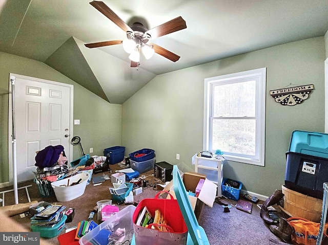 interior space with carpet, ceiling fan, and vaulted ceiling