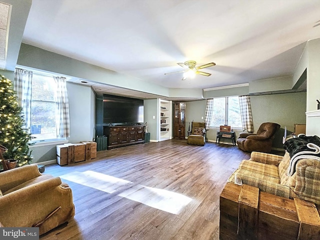 living room featuring ceiling fan and wood-type flooring