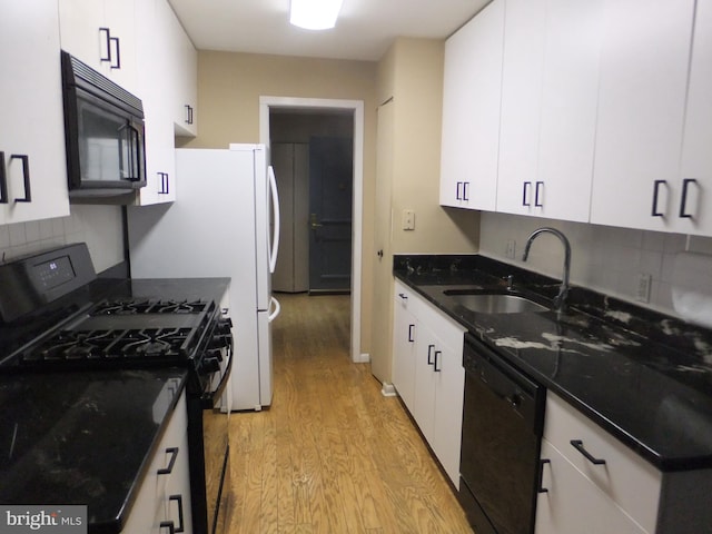 kitchen featuring light hardwood / wood-style floors, white cabinetry, sink, black appliances, and tasteful backsplash