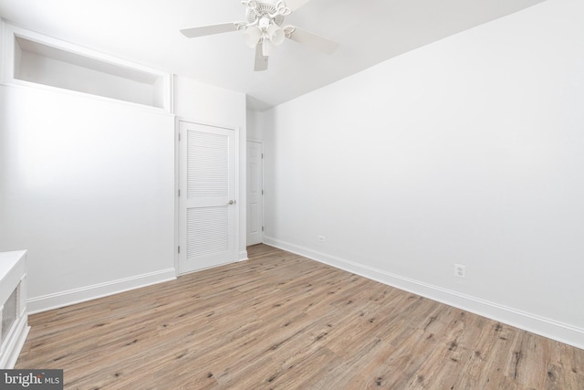 unfurnished bedroom with ceiling fan, a closet, and light hardwood / wood-style floors