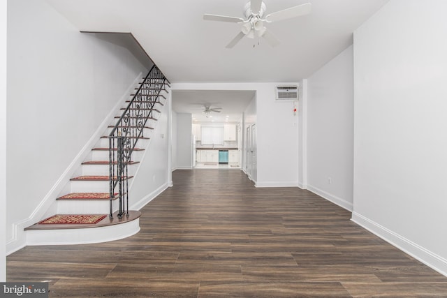 interior space featuring a wall unit AC, dark hardwood / wood-style flooring, and ceiling fan