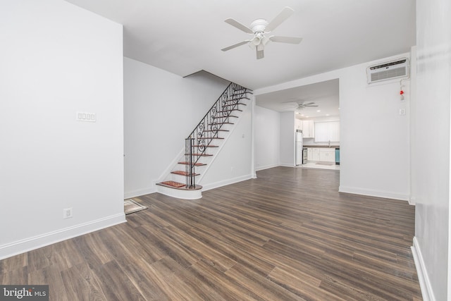 unfurnished living room featuring ceiling fan, a wall mounted air conditioner, and dark hardwood / wood-style flooring