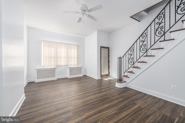 unfurnished living room featuring ceiling fan and dark hardwood / wood-style floors