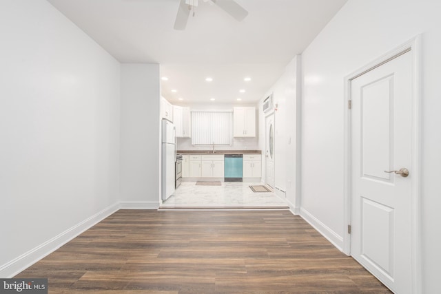 interior space with ceiling fan, dark wood-type flooring, and sink