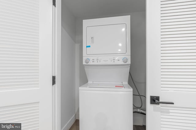 laundry room featuring stacked washer / drying machine