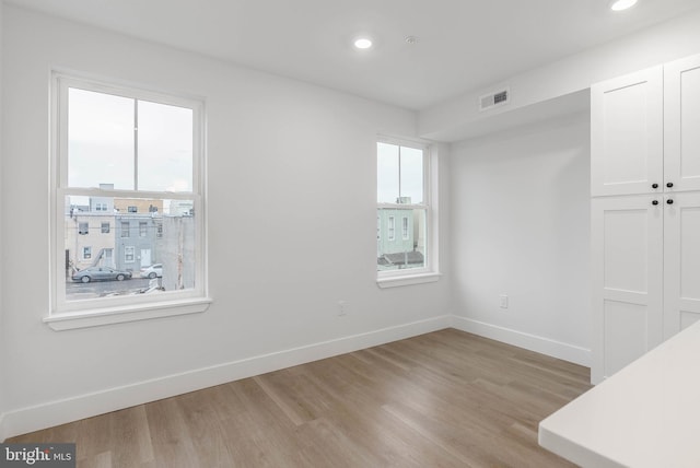 spare room featuring light wood-type flooring