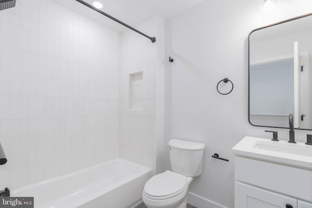 full bathroom featuring vanity, tiled shower / bath combo, and toilet