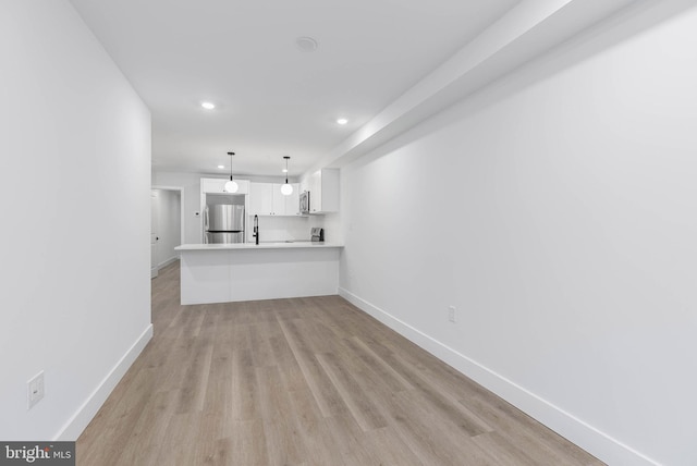 unfurnished living room featuring light hardwood / wood-style floors