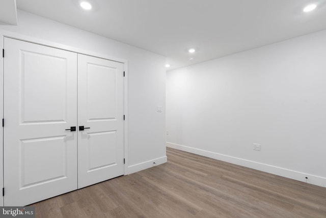 unfurnished bedroom featuring light hardwood / wood-style floors and a closet