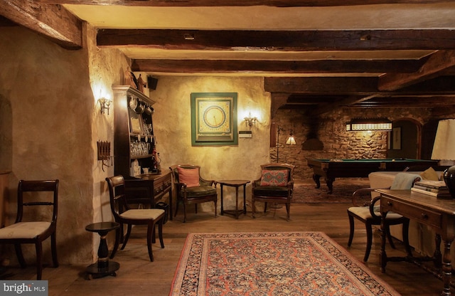 living area featuring beam ceiling, hardwood / wood-style floors, and billiards