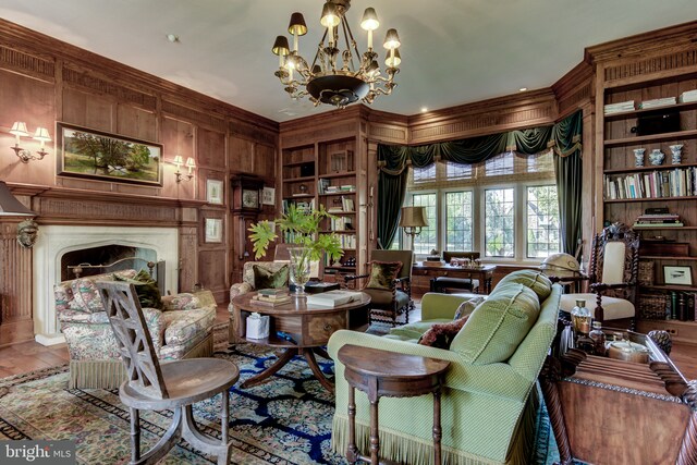 1601 Brintons Bridge Rd, Chadds Ford, PA 19317 - living area with an inviting chandelier, wooden walls, crown molding, wood finished floors, and a premium fireplace