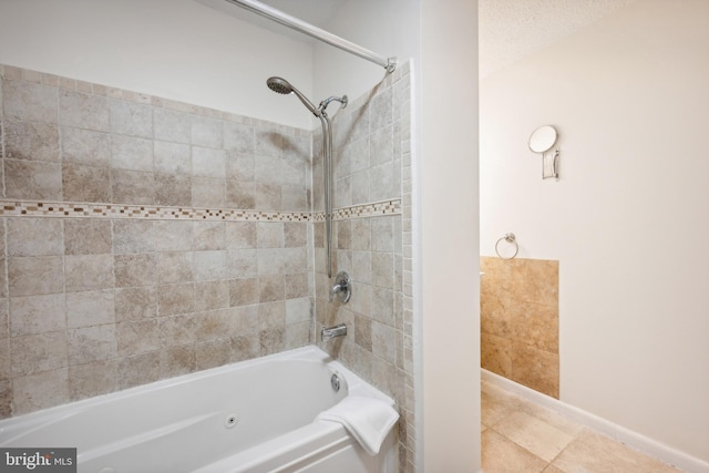 bathroom featuring tile patterned floors, tiled shower / bath combo, and a textured ceiling