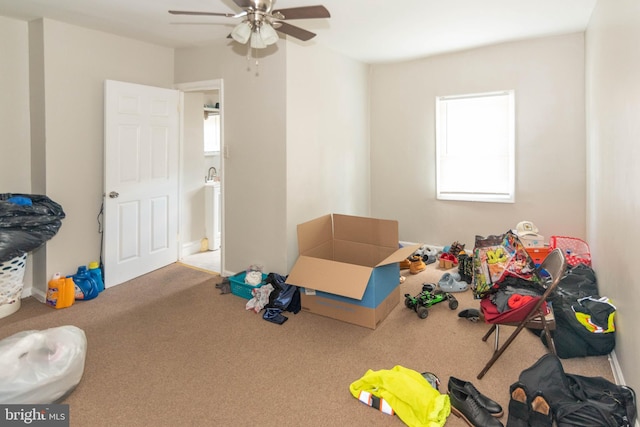 game room featuring ceiling fan, a healthy amount of sunlight, and carpet flooring