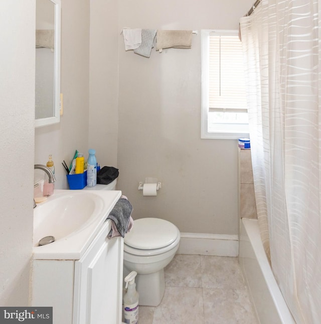 full bathroom featuring vanity, toilet, shower / bath combo with shower curtain, and tile patterned flooring