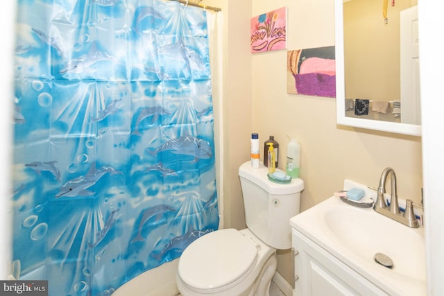 bathroom featuring toilet, curtained shower, and vanity