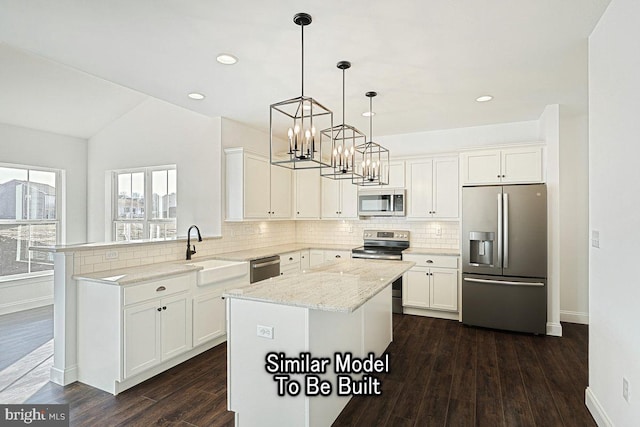 kitchen with stainless steel appliances, a center island, lofted ceiling, and pendant lighting