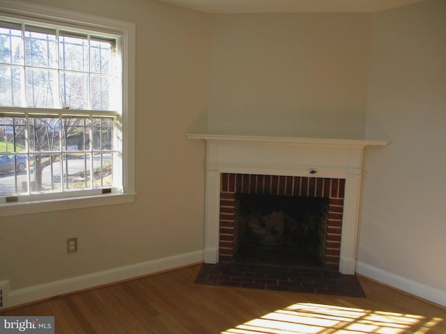 unfurnished living room featuring dark hardwood / wood-style flooring and a fireplace