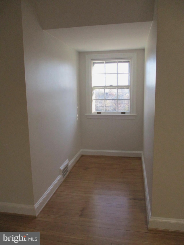 unfurnished room with dark hardwood / wood-style flooring