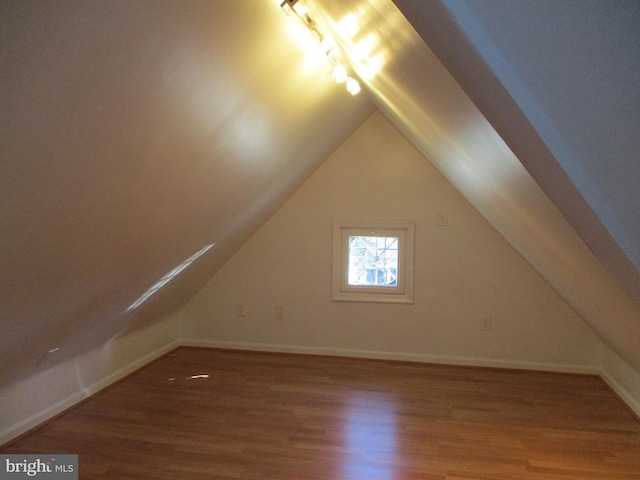 bonus room featuring wood-type flooring and vaulted ceiling