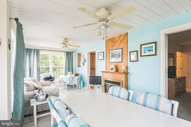 dining space with ceiling fan and concrete flooring