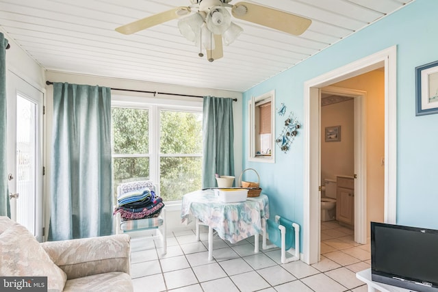 sunroom with wood ceiling and ceiling fan