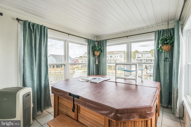 dining room with light tile patterned floors and wooden ceiling