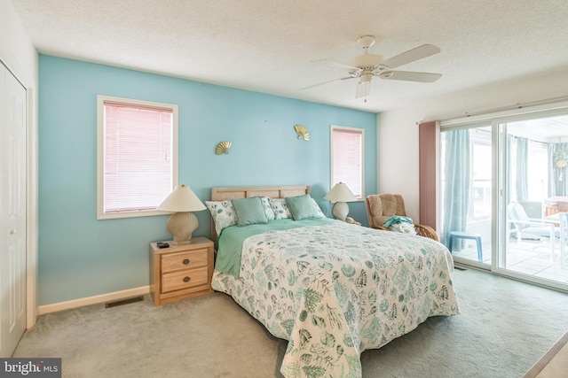 bedroom featuring access to exterior, ceiling fan, a closet, and light colored carpet