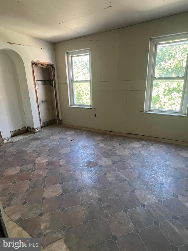 unfurnished bedroom featuring multiple windows