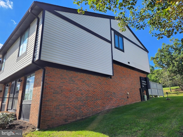 view of side of home with a yard