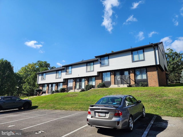 townhome / multi-family property featuring a front yard