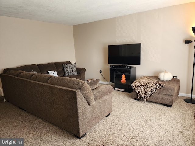 carpeted living room featuring a textured ceiling