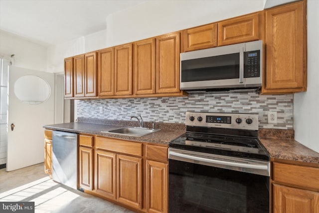 kitchen with stainless steel appliances, tasteful backsplash, and sink