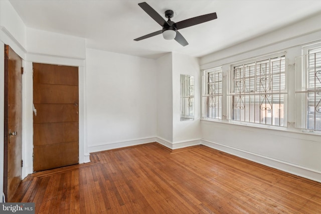 unfurnished room with ceiling fan and hardwood / wood-style floors