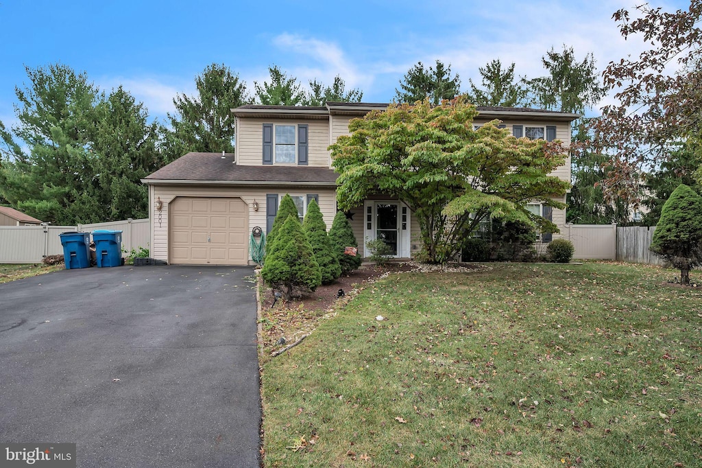 view of front of property featuring a front yard and a garage