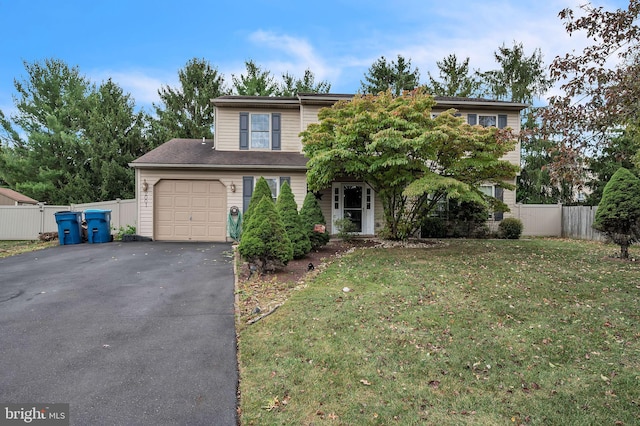 view of front of property featuring a front yard and a garage