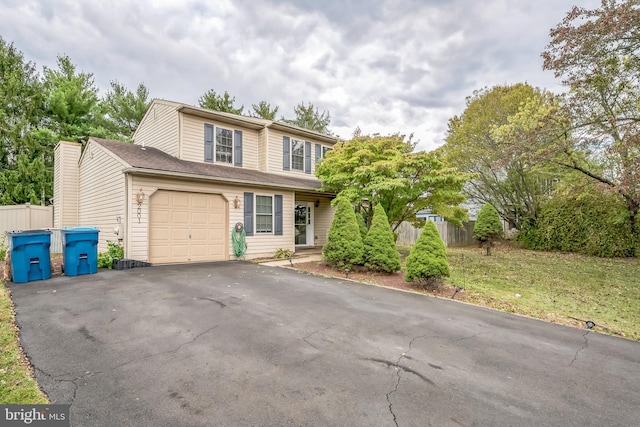 view of front property with a front lawn and a garage