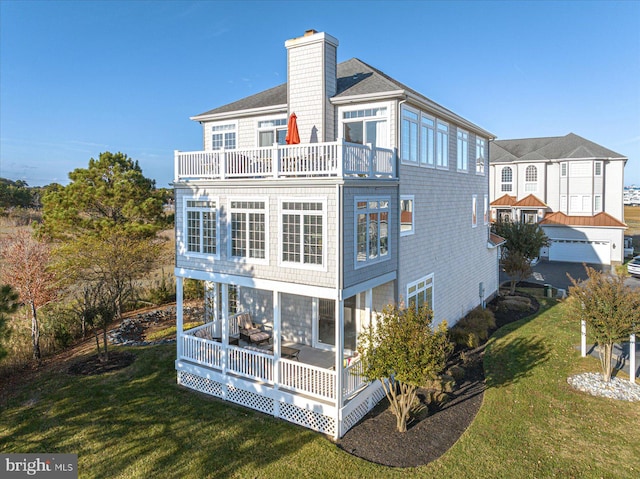 back of property featuring a yard and a balcony