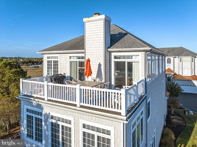 back of property with a sunroom