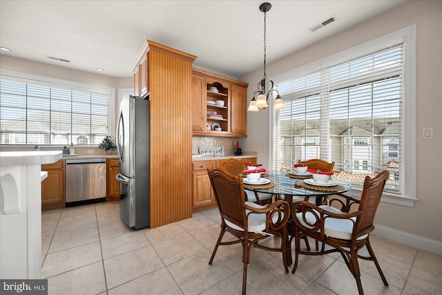 tiled dining room featuring a notable chandelier