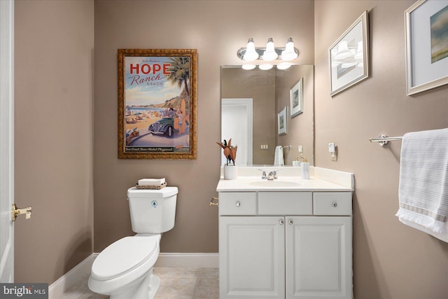 bathroom featuring toilet, vanity, and tile patterned floors